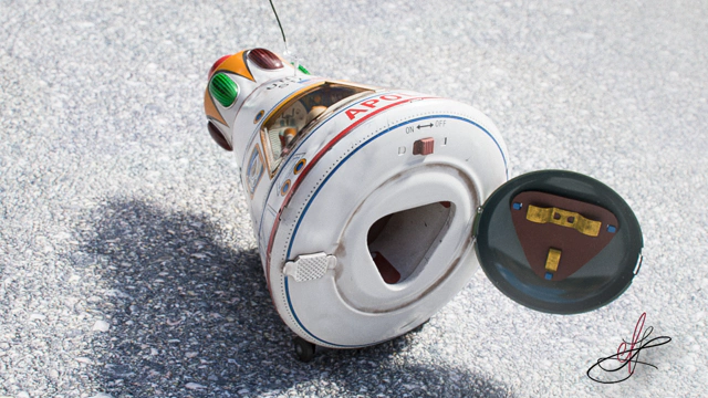 Full shot of toy's back side revealing an open, but empty battery compartment.