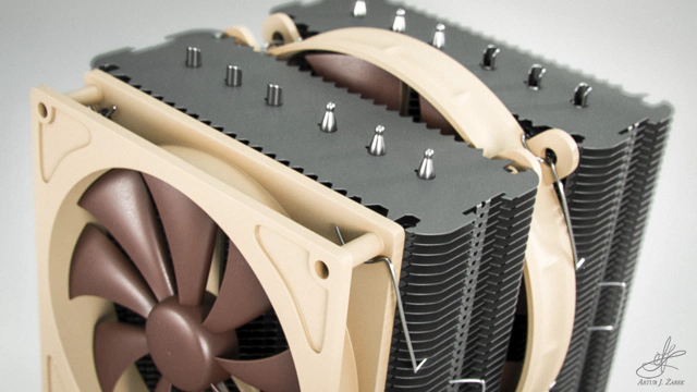 A close up of a top-left side of a massive double-fanned CPU cooler with two aluminium radiator columns. The fans are brown and mounted in a tan casing