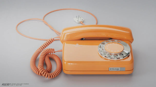 Front side of a glossy orange rotary dial telephone.