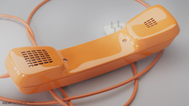 A close-up on the curved receiver. It has a grid of rectangular holes on its both ends, which expose the large metallic microphone and the speaker. From underneath the receiver, a plug pokes out.